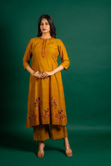 Mustard A-line handloom top with thread work on neck, the Daman is highlighted with appliqué work and sequin detailing, and cotton pant
