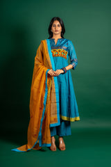 Blue handloom Kali top paired with ikat and Kutch work on yoke with mustard dupatta with work and pant