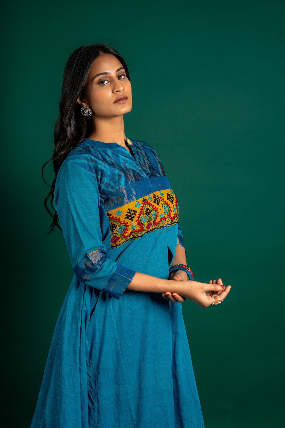 Blue handloom Kali top paired with ikat and Kutch work on yoke with mustard dupatta with work and pant
