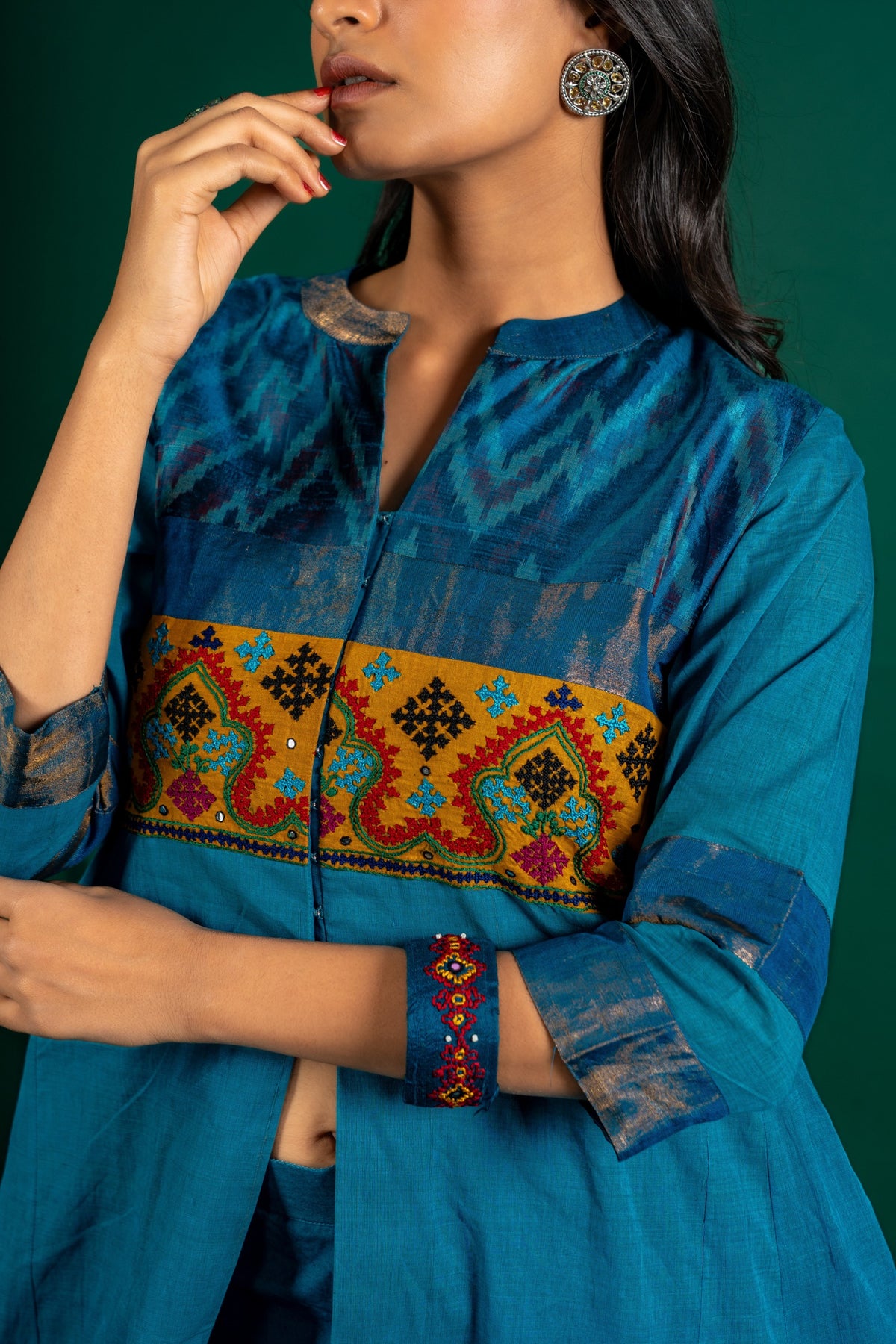 Blue handloom Kali top paired with ikat and Kutch work on yoke with mustard dupatta with work and pant