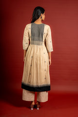 Beige shade with black thread butta in the centre, a temple border on the Daman, and thread with mirror detailing on the yoke, cotton pant
