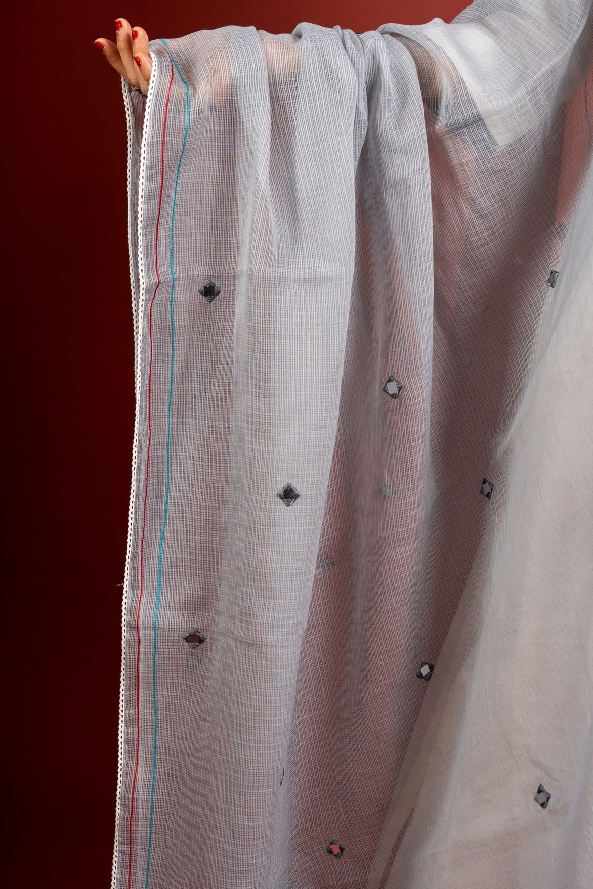Off white and grey panel handloom top, kanta work on yoke with grey Kota dupatta with mirror work, tie and dye pant
