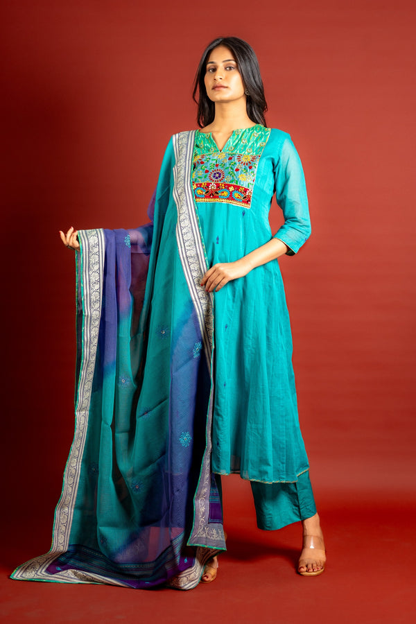 Vibrant turquoise blue kali handloom top, multicolour thread embroidery with mirror work on yoke and tie and dye shaded dupatta with work and self colour pant