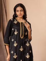 Black linen satin straight-cut top with Gota Patti and threadwork bhutis, paired with rayon pants.