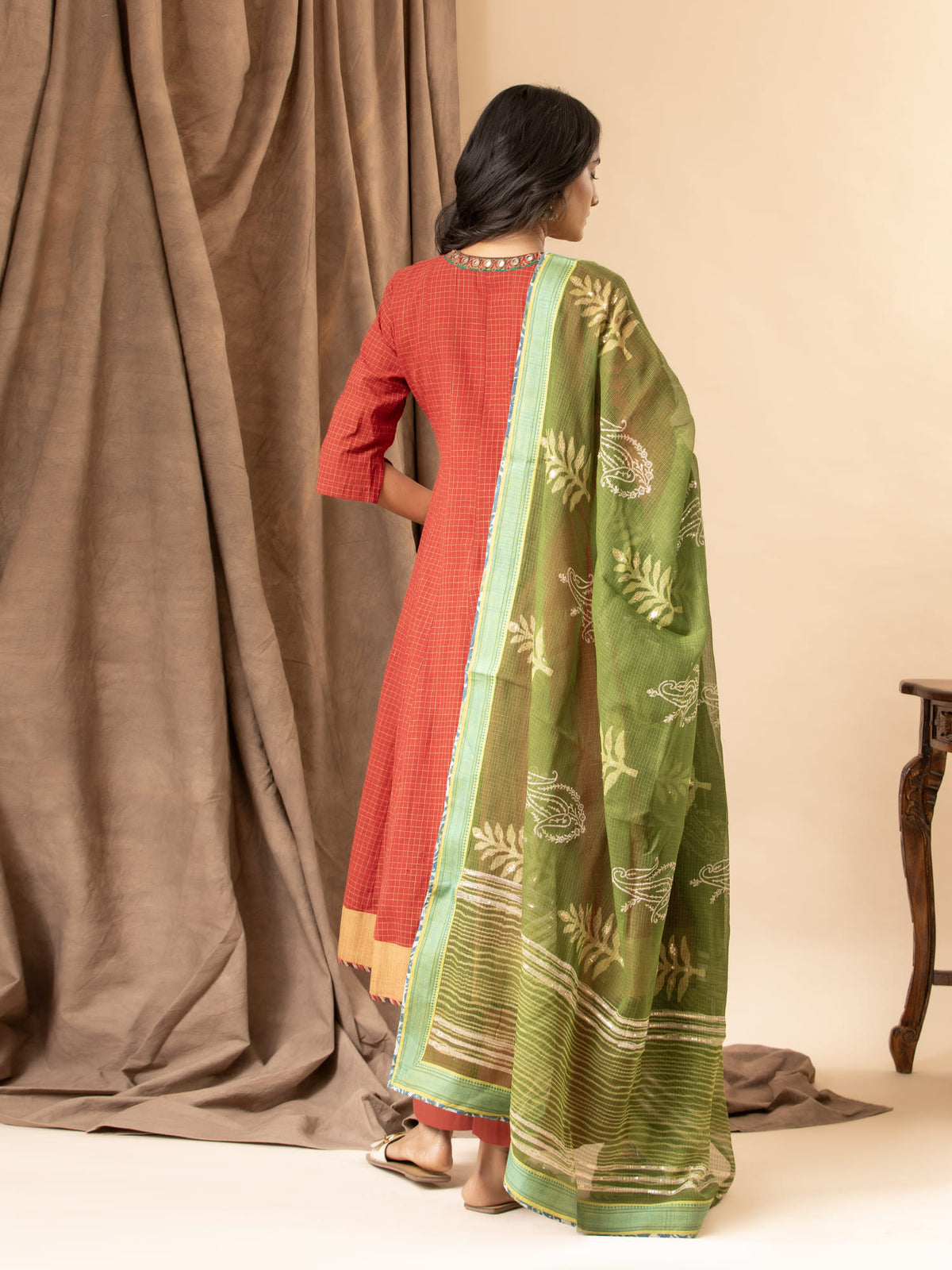 Burnt red handloom checkered kalidar with a green printed Kota dupatta highlighted with sequins, paired with loose pants