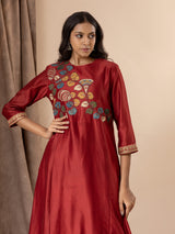Crimson red Chanderi panel top with hand-painted Kalamkari applique work, paired with printed pants