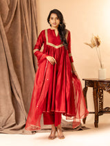 Crimson red Chanderi top with kali and gathered design, featuring golden detailing on the yoke and sleeves. paired with an organza dupatta