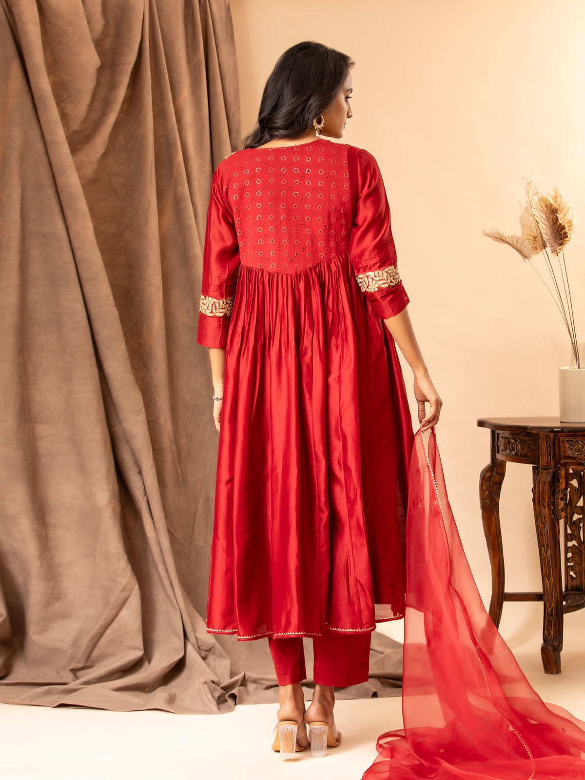 Crimson red Chanderi top with kali and gathered design, featuring golden detailing on the yoke and sleeves. paired with an organza dupatta