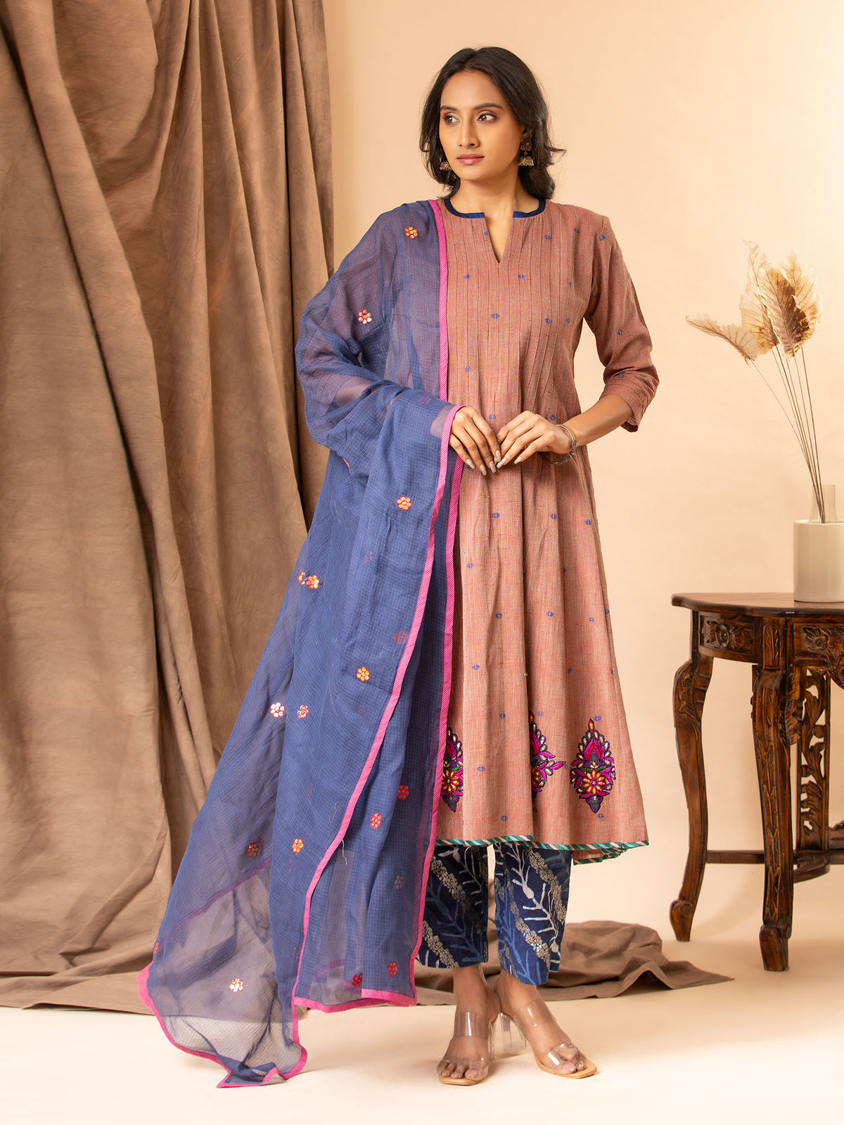 Dusky mauve handwoven kali top with Gota and thread work bhuttis on the kalis, paired with printed pants and a koti dupatta featuring Gota Patti work