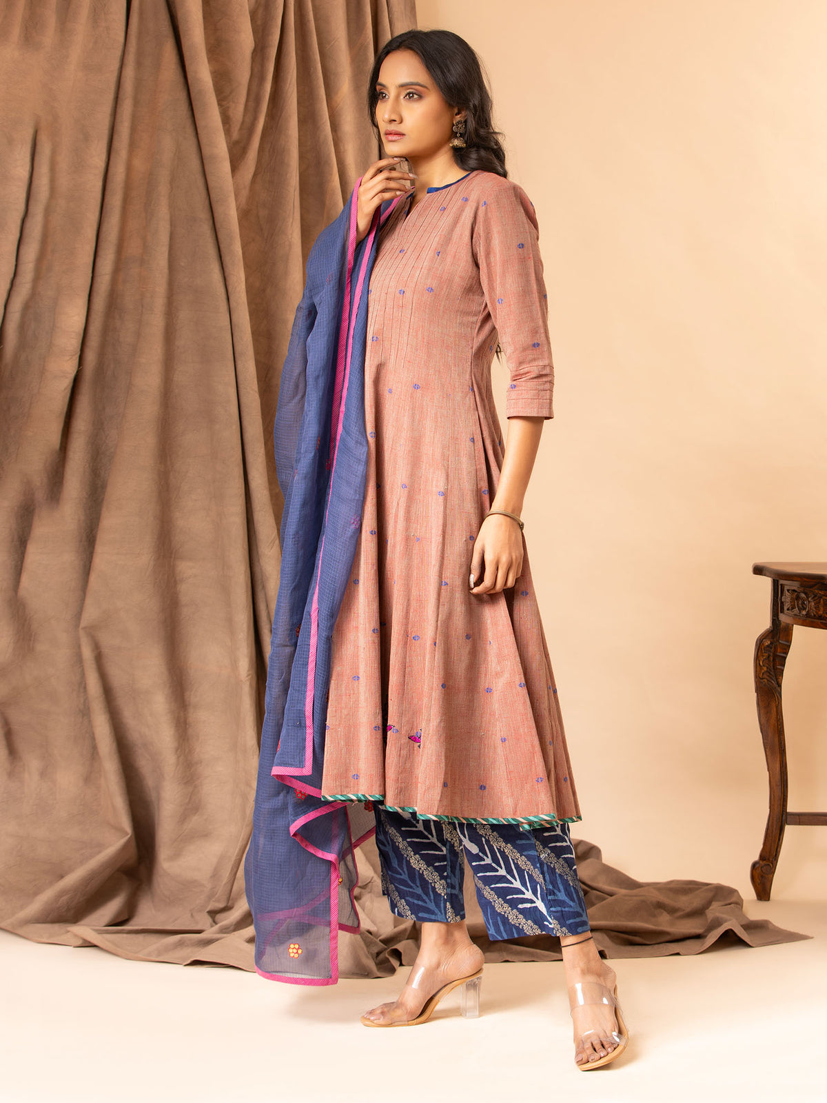 Dusky mauve handwoven kali top with Gota and thread work bhuttis on the kalis, paired with printed pants and a koti dupatta featuring Gota Patti work