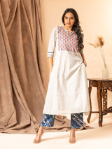Handwoven light grey A-line panel top with handwork yoke featuring thread and mirror work, paired with blue printed pants