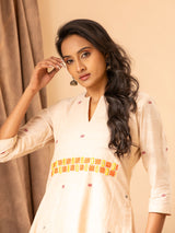 Handwoven panel top in creamy peach with thread and mirror work, paired with matching pants