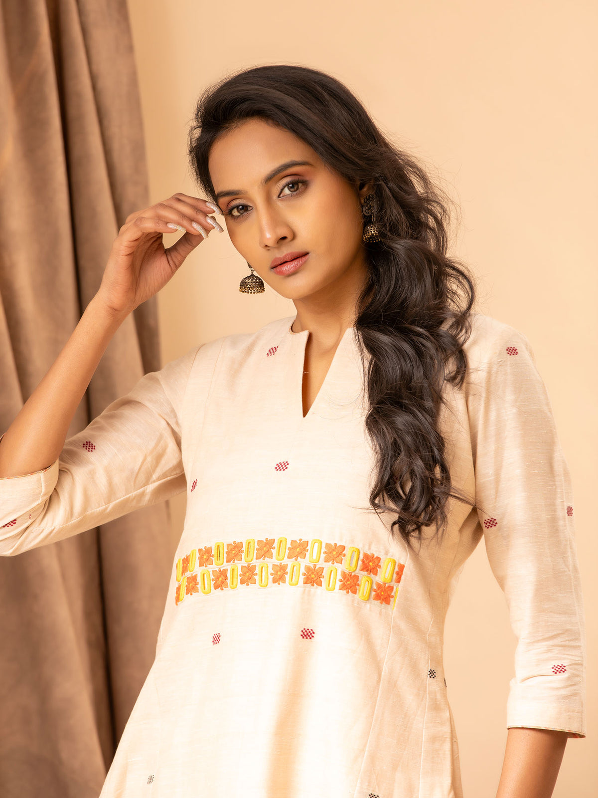 Handwoven panel top in creamy peach with thread and mirror work, paired with matching pants
