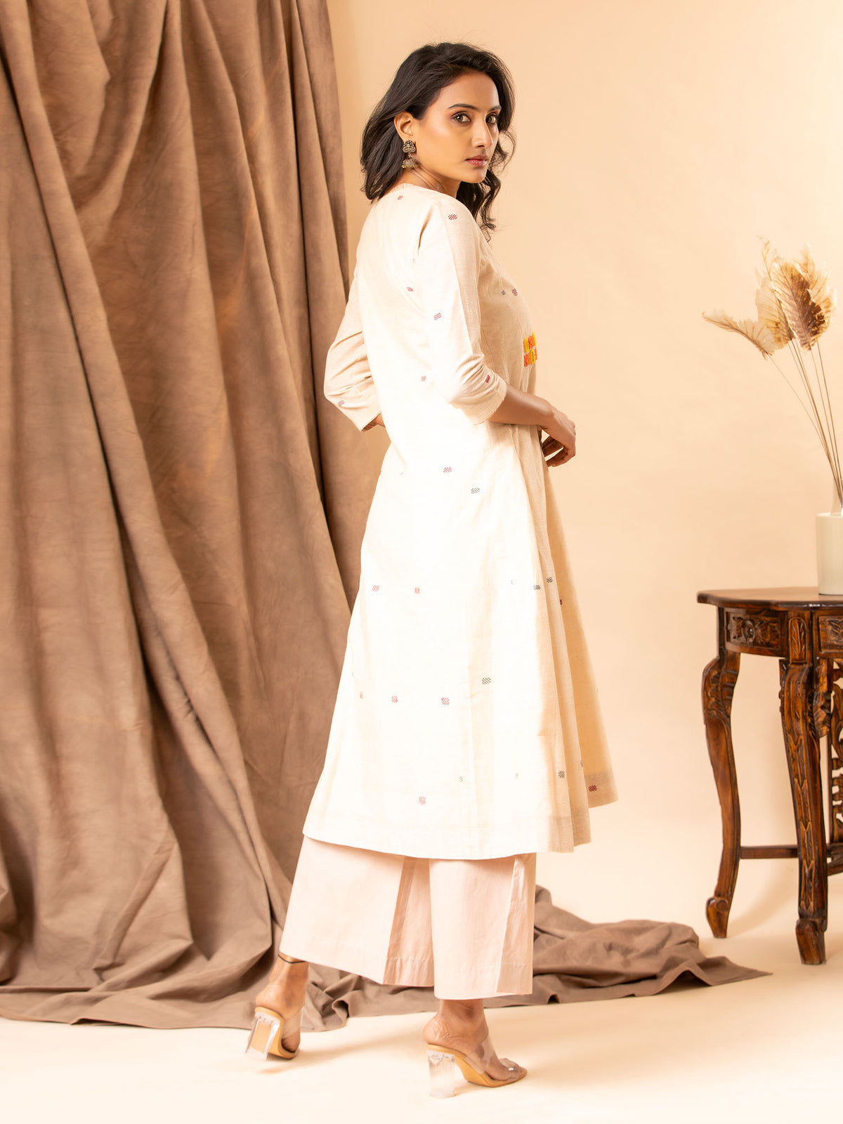 Handwoven panel top in creamy peach with thread and mirror work, paired with matching pants