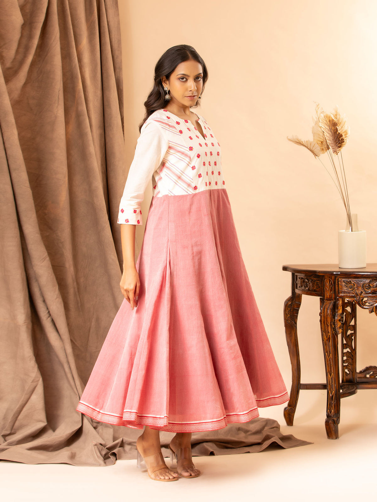 Handwoven white and red kali frock with thread work yoke and intricate thread work lines.