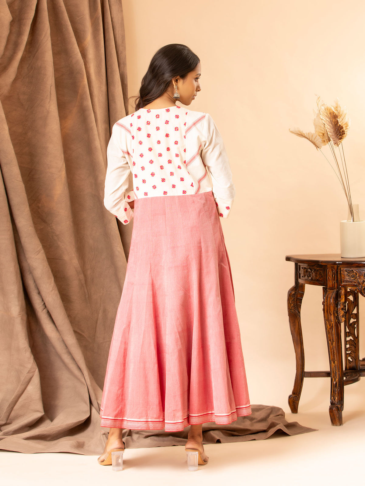 Handwoven white and red kali frock with thread work yoke and intricate thread work lines.