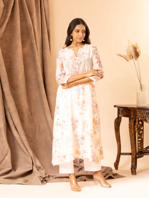 Ivory floral printed Chanderi straight cut top with embroidery on the yoke, paired with stretchable Lycra pants