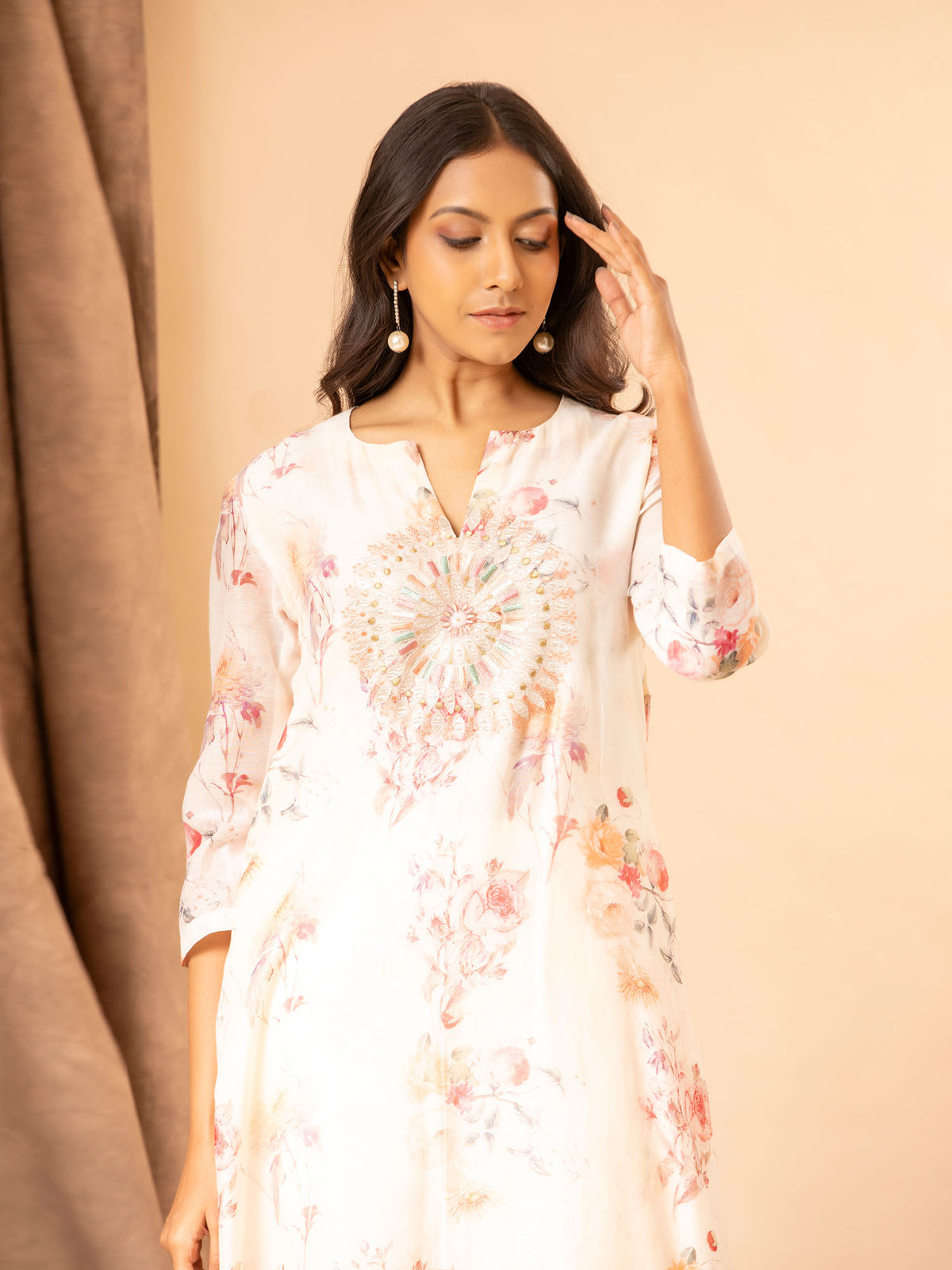 Ivory floral printed Chanderi straight cut top with embroidery on the yoke, paired with stretchable Lycra pants