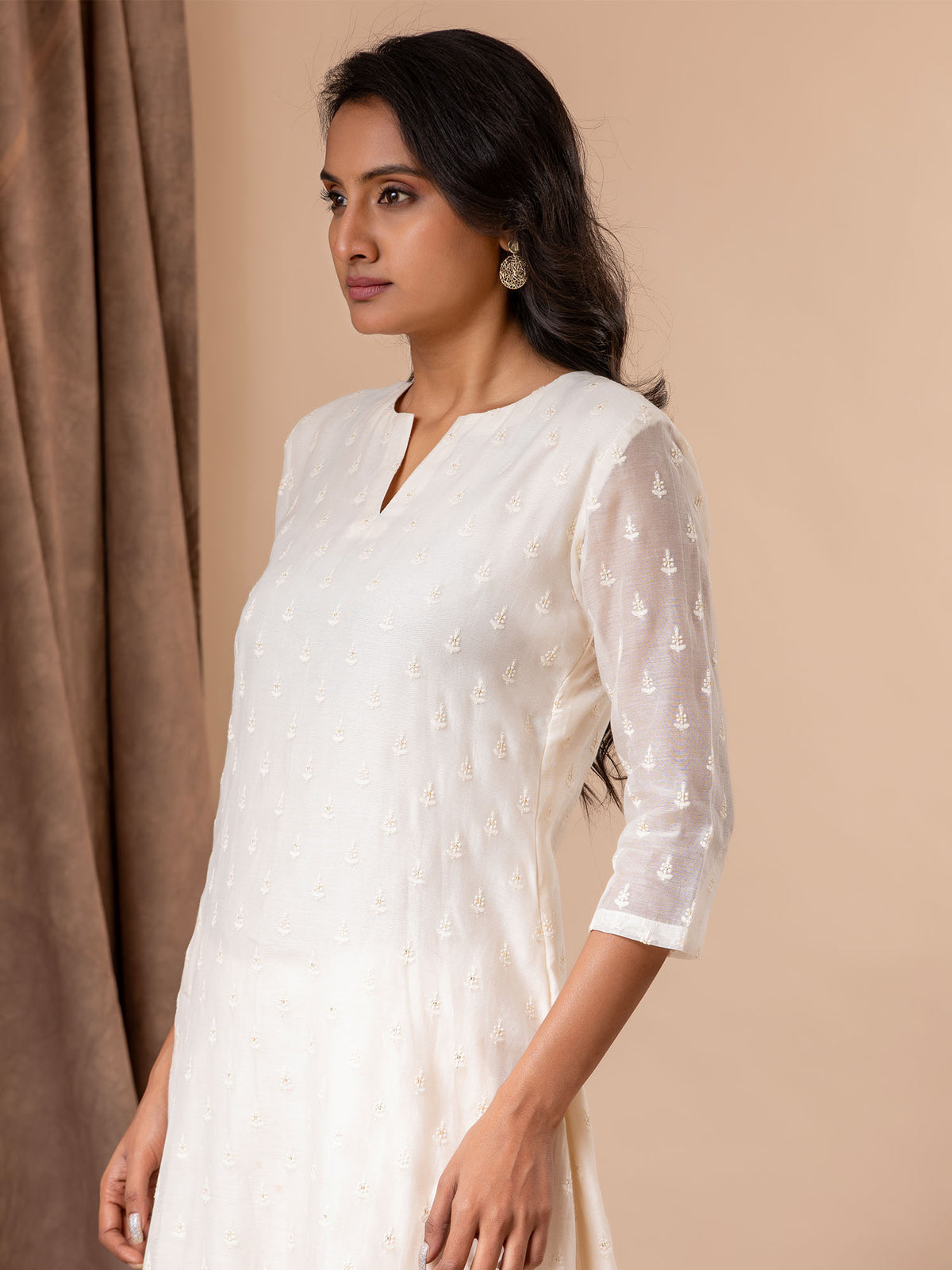 Ivory thread work Chanderi top with a Chanderi dupatta featuring all-over embroidery, paired with pants