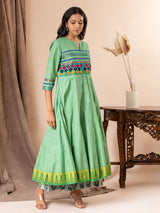 Light green kali top with Kutch work and mirror work, paired with batik printed pants