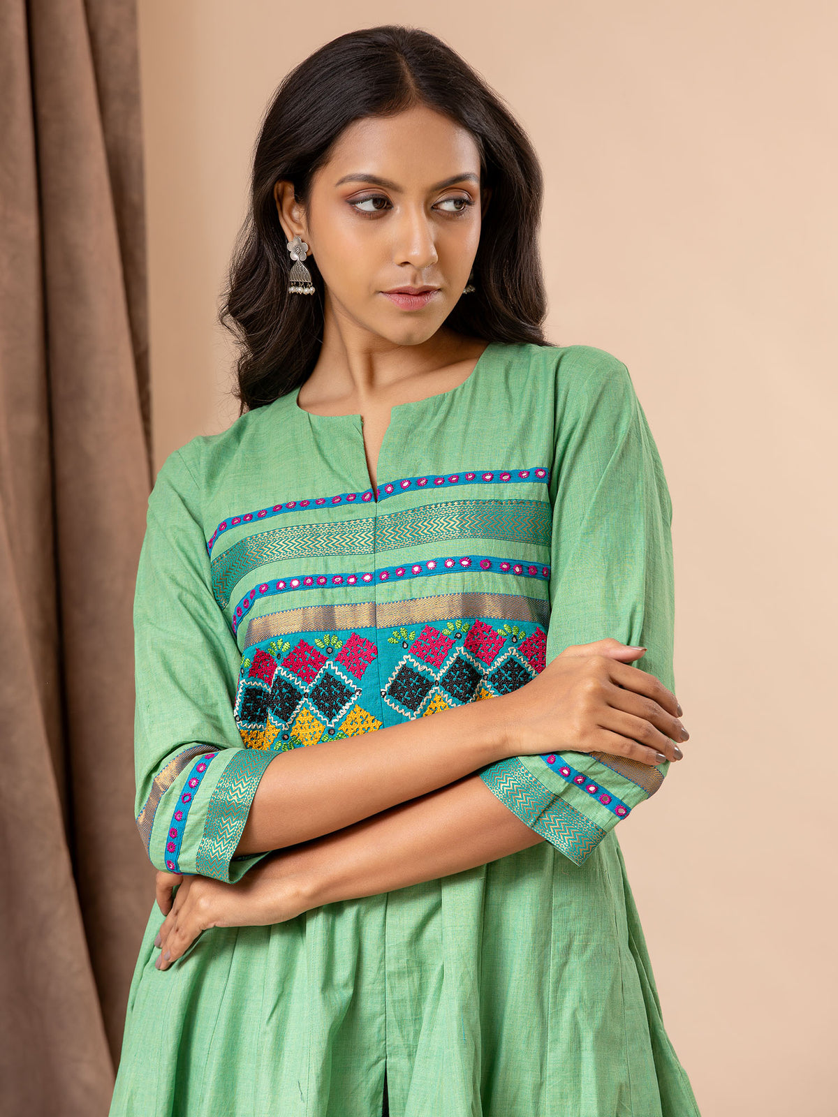 Light green kali top with Kutch work and mirror work, paired with batik printed pants