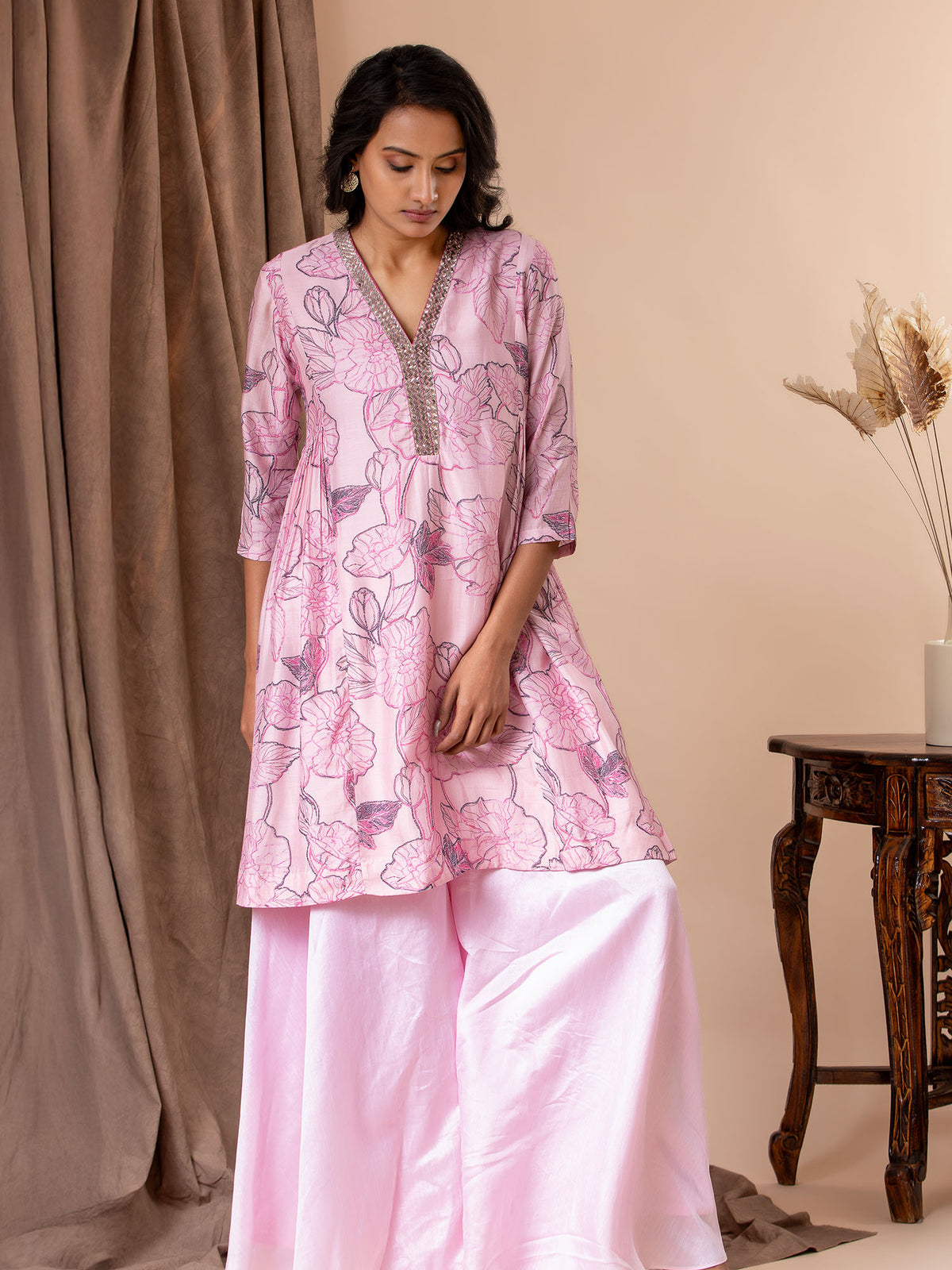 Light pink printed silk sharara top with hand-embroidered neckline, paired with loose sharara pants
