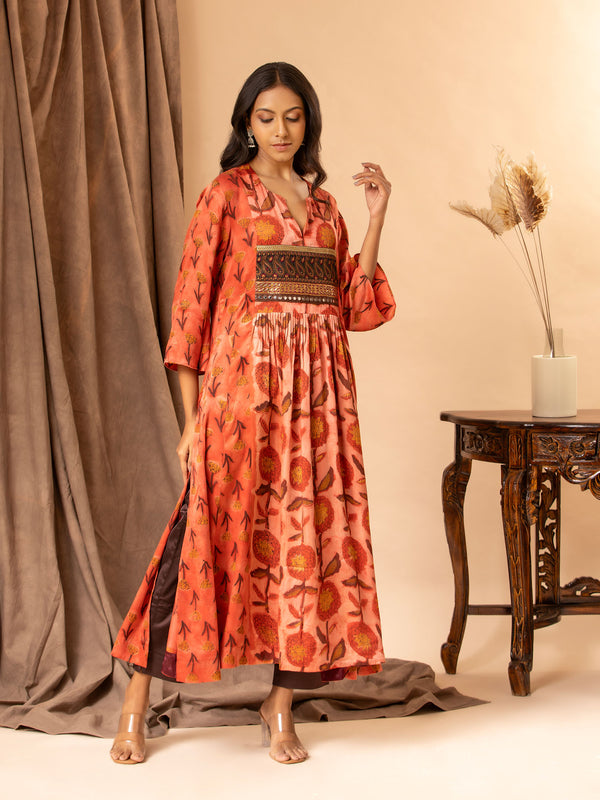 Mushroo printed silk gathered and panel top in burnt orange, with detailing on the yoke, paired with plain brown stretchable pants