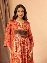 Mushroo printed silk gathered and panel top in burnt orange, with detailing on the yoke, paired with plain brown stretchable pants