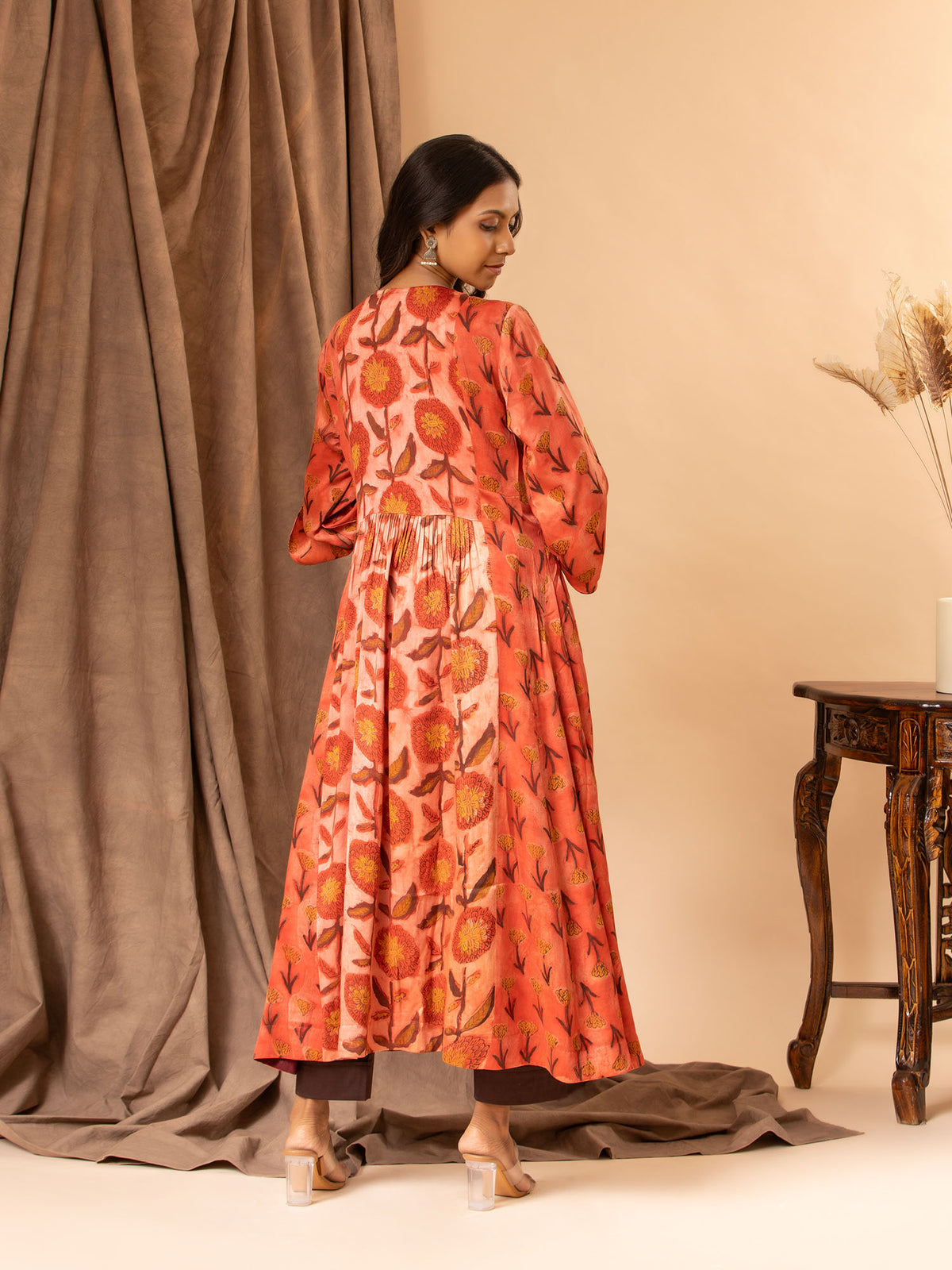 Mushroo printed silk gathered and panel top in burnt orange, with detailing on the yoke, paired with plain brown stretchable pants