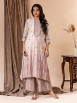Muslin top in shades of mauve with all over thread and mirror handwork, paired with pants.