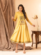 Mustard yellow handwoven dress with zall over zari bhuti and thread embroidery on the yoke.