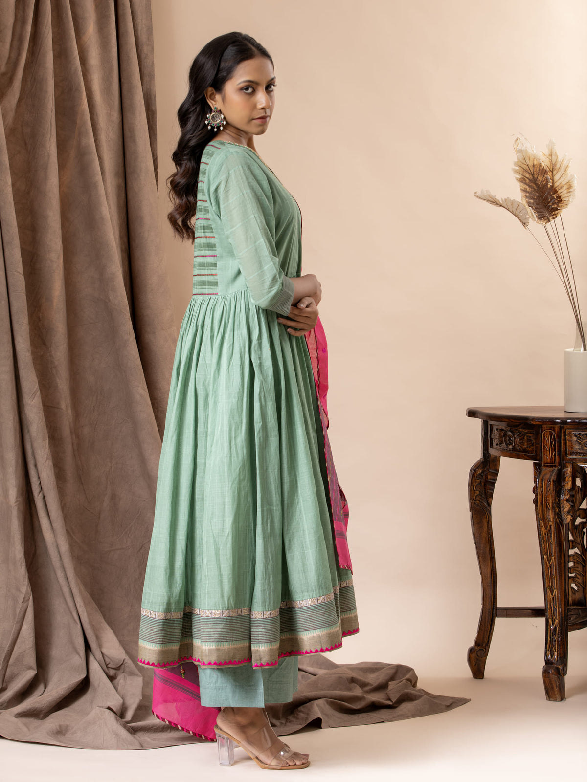Muted teal handwoven top paired with a pink handwoven dupatta featuring thread work detailing, and matching pants
