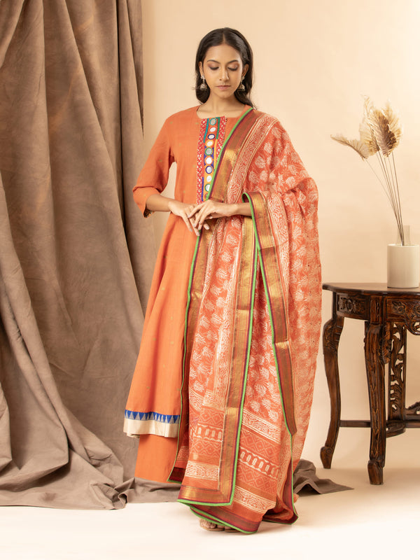 Orange handloom top with Banjara mirror work, paired with a printed Kota dupatta highlighted with sequins and matching pants