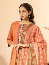 Orange handloom top with Banjara mirror work, paired with a printed Kota dupatta highlighted with sequins and matching pants