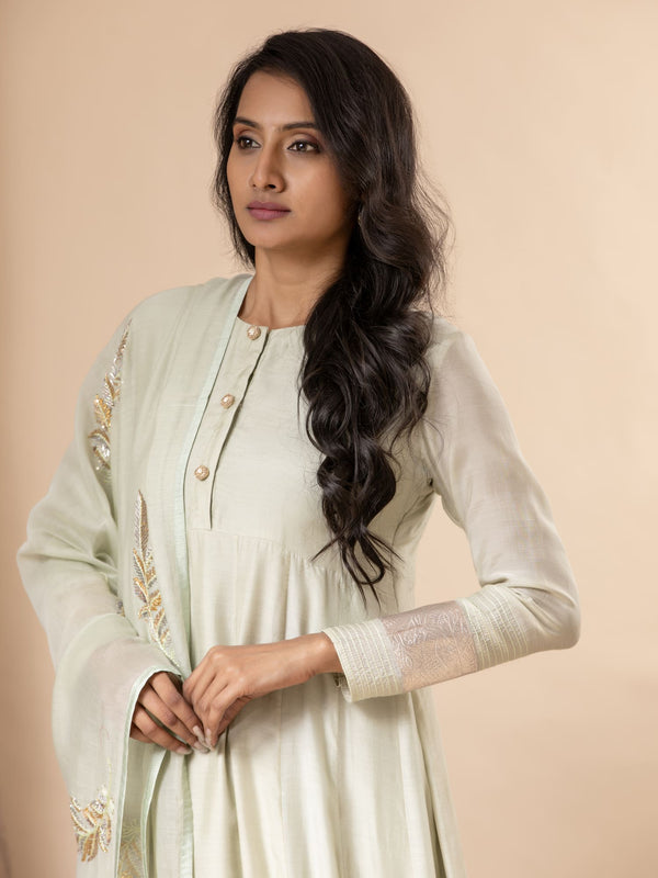 Powder green muslin top with Gota detailing on the sleeves, paired with an intricate feather detailing hand-embroidered dupatta