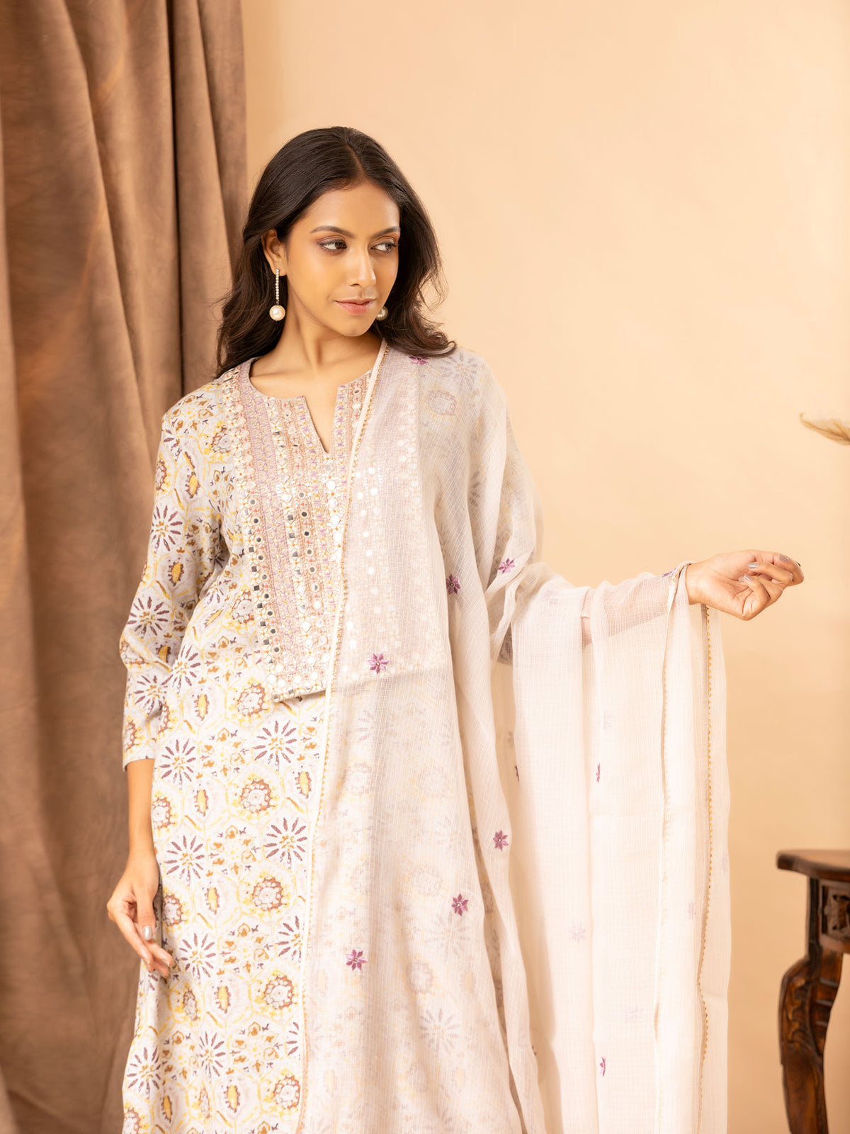 Printed linen top with handembroidered thread and mirror work on the yoke, paired with a Kota dupatta featuring thread work and matching pants