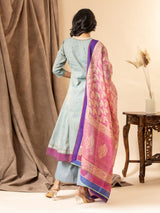 Slate blue handwoven kali top with a pink printed Kota dupatta highlighted with sequins, paired with loose pants. The top features an intricate hand-embroidered neckline