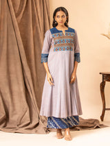Soft grey handwoven kali top with Kutch work and mirror yoke, featuring Kalamkari patchwork on the back, paired with printed Chanderi pants