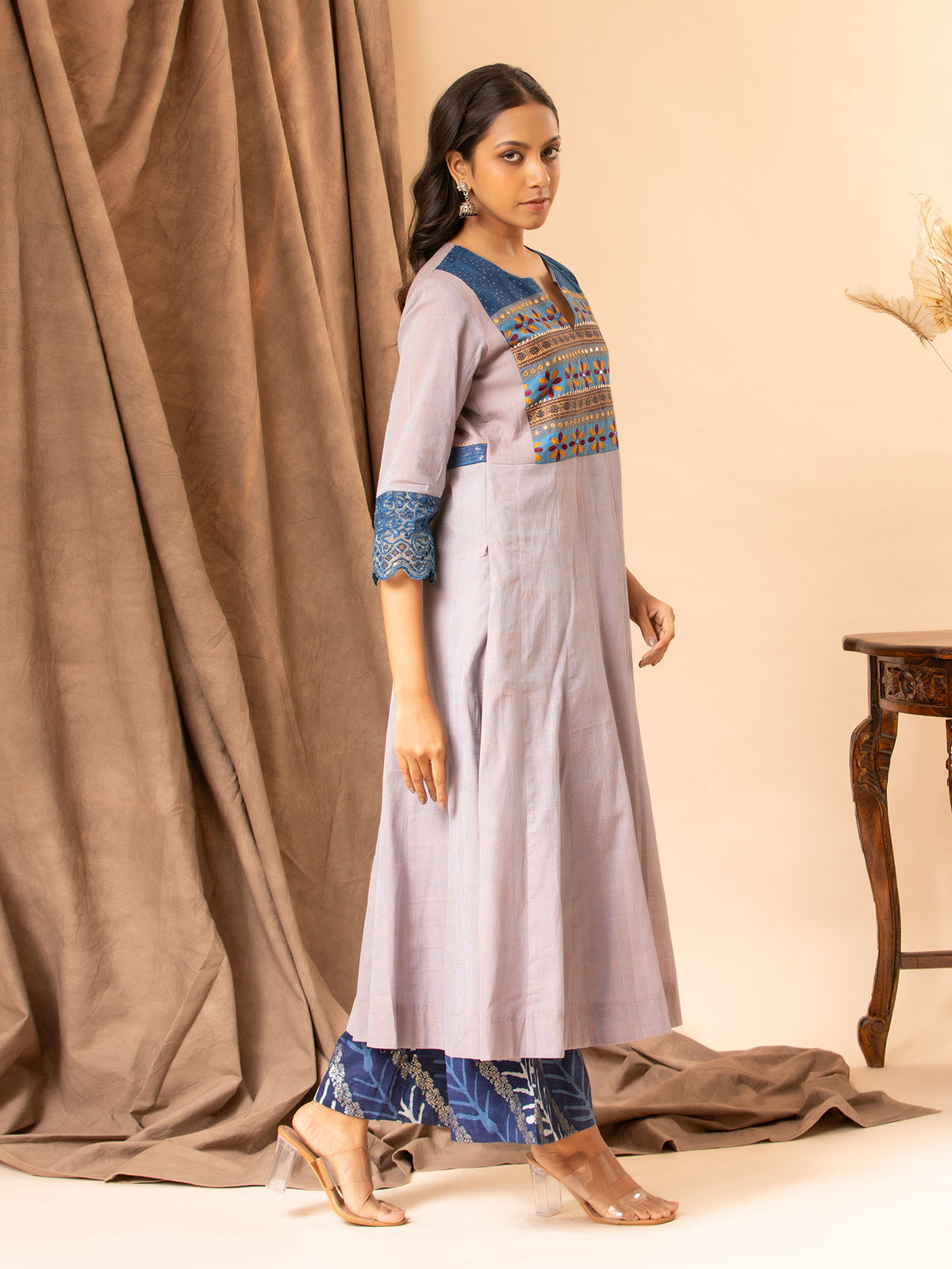 Soft grey handwoven kali top with Kutch work and mirror yoke, featuring Kalamkari patchwork on the back, paired with printed Chanderi pants