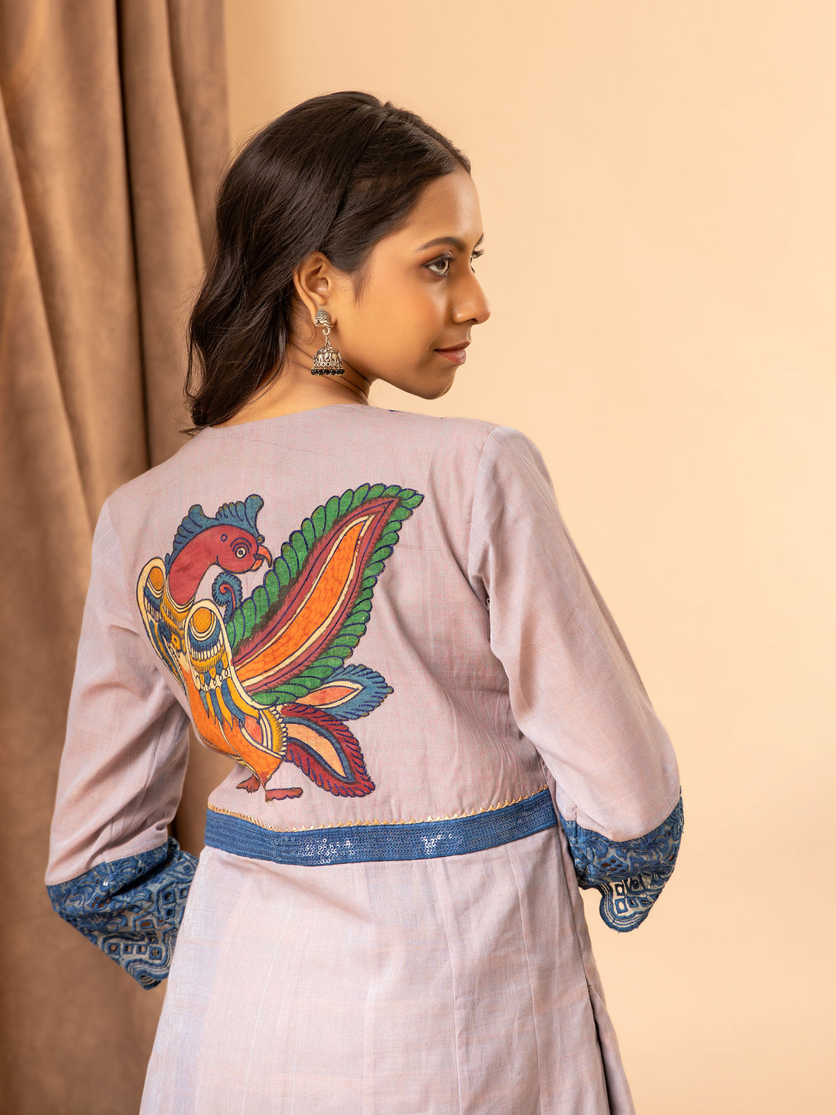 Soft grey handwoven kali top with Kutch work and mirror yoke, featuring Kalamkari patchwork on the back, paired with printed Chanderi pants