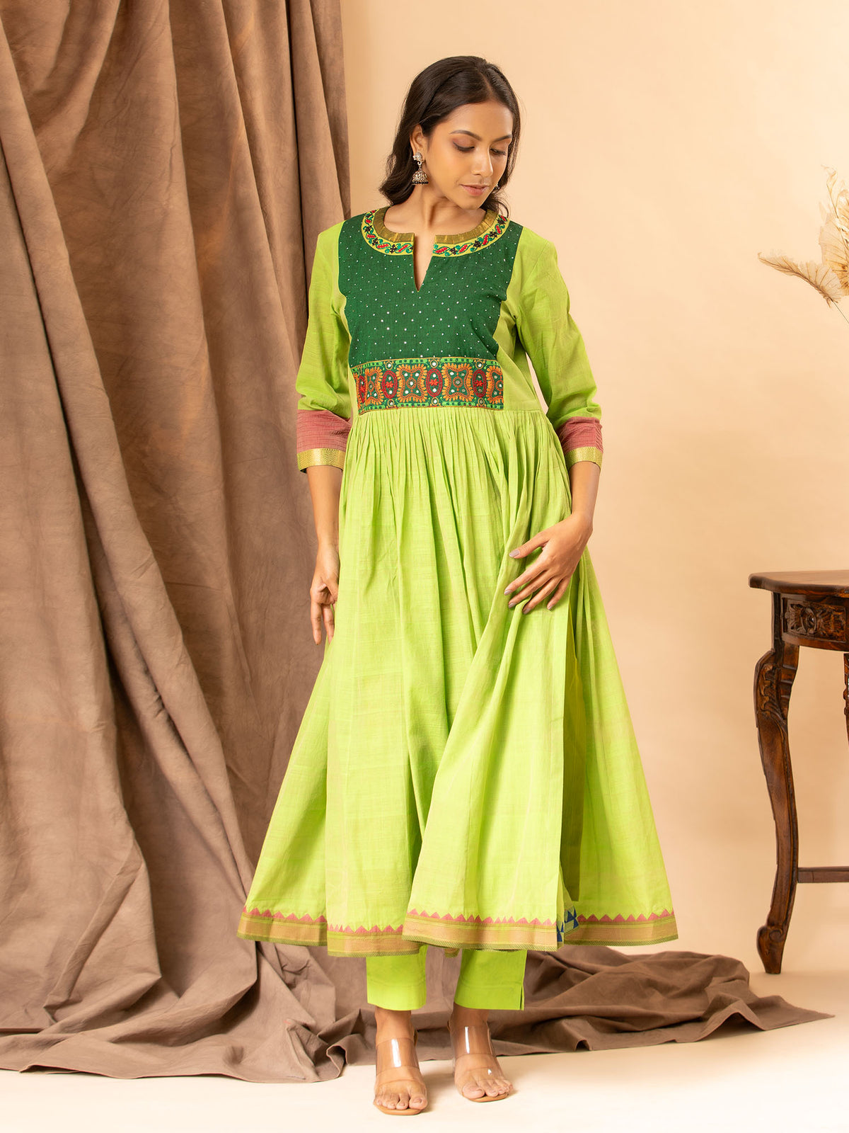 Vibrant green handwoven gathered top with tiny mirror and Kutch work on the yoke, paired with matching pants