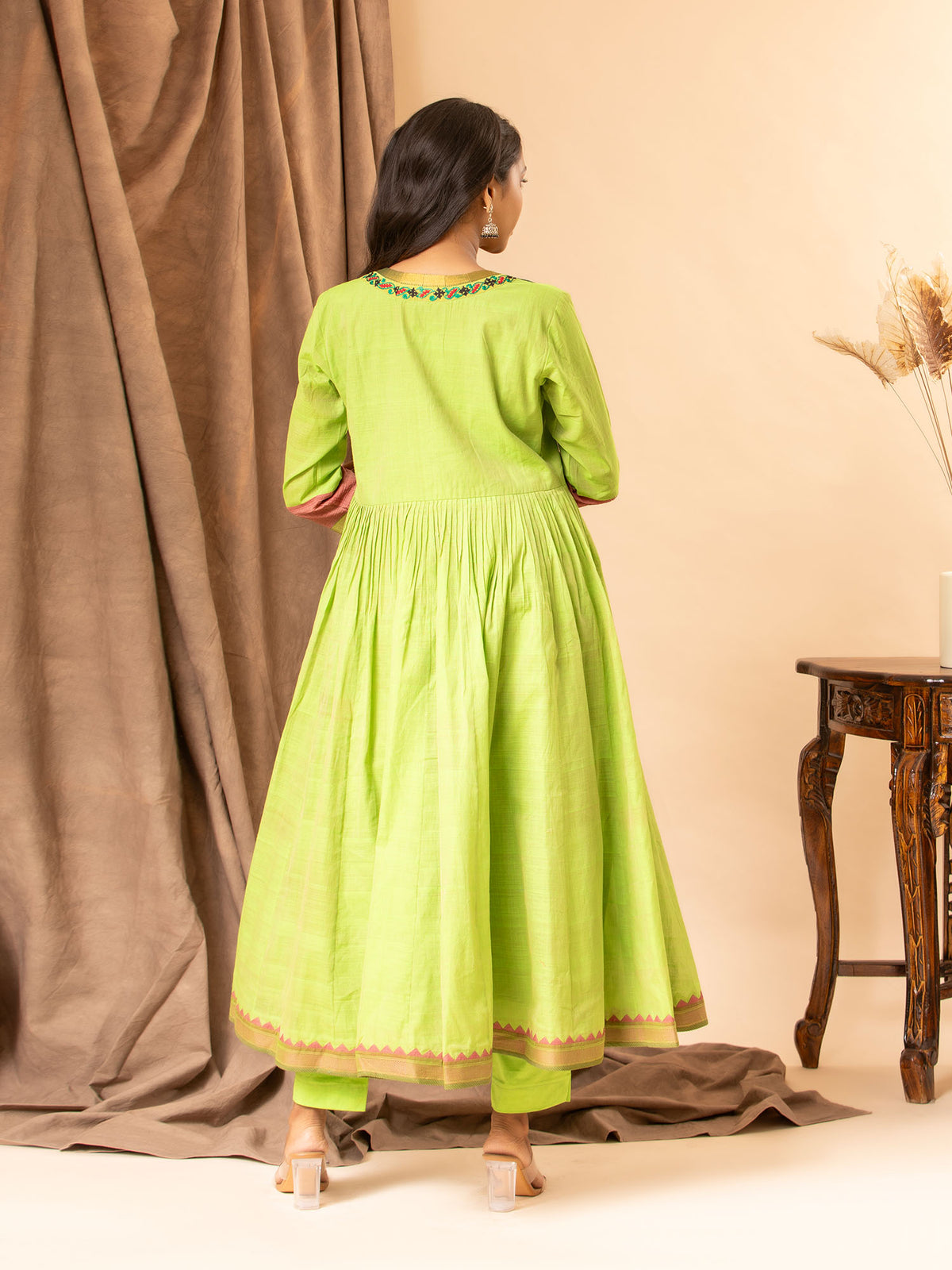 Vibrant green handwoven gathered top with tiny mirror and Kutch work on the yoke, paired with matching pants