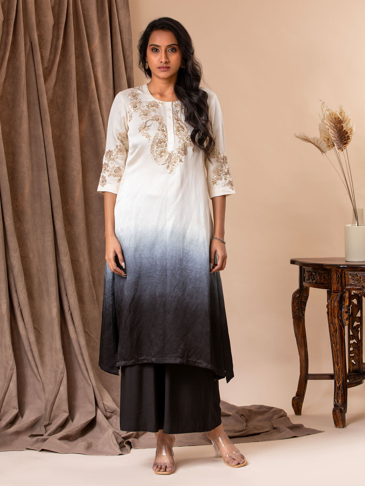 White to black ombre-shaded linen satin straight-cut top with detailed Gota hand embroidery, paired with black pants.