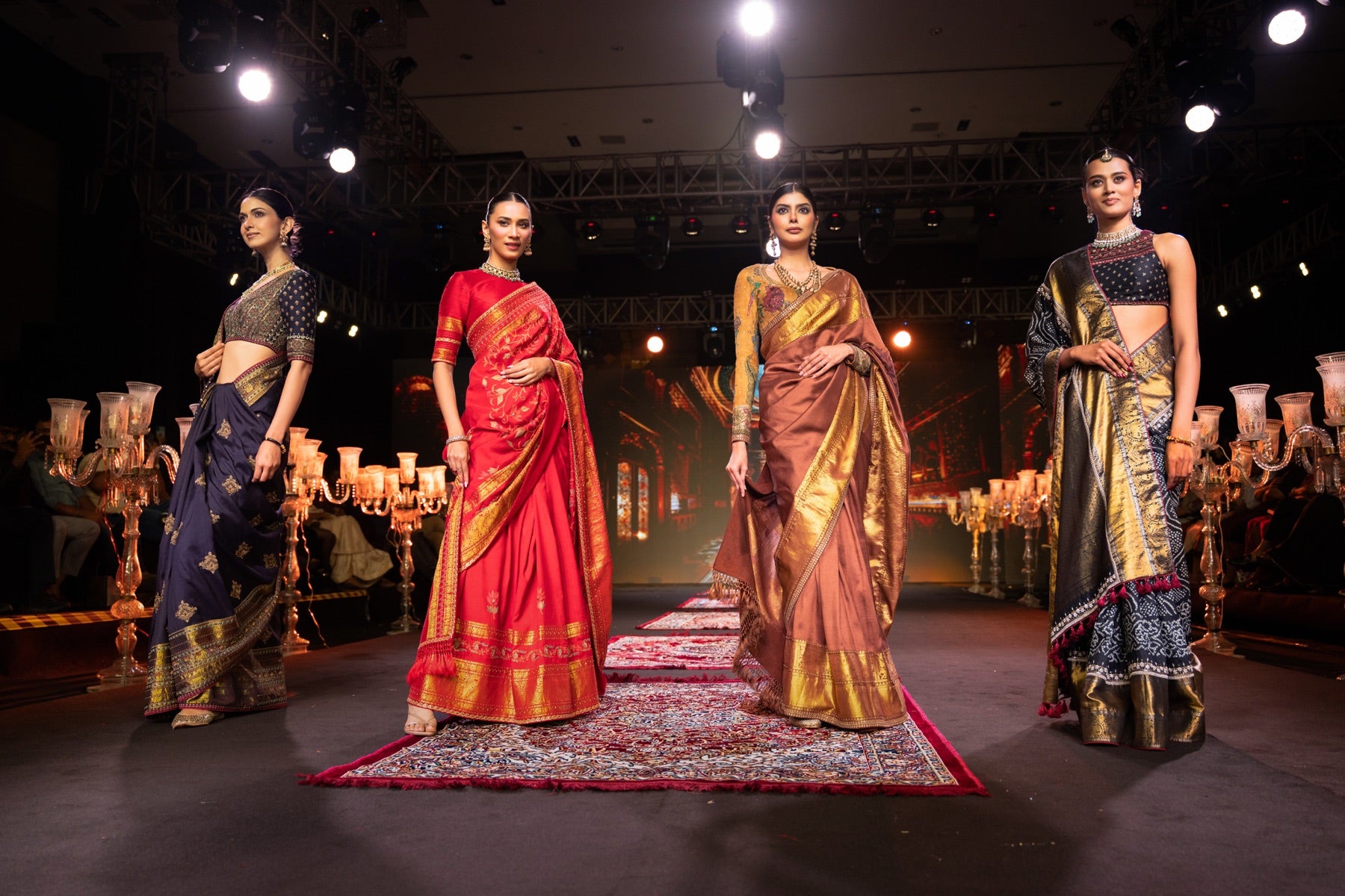 Four models walking the runway together