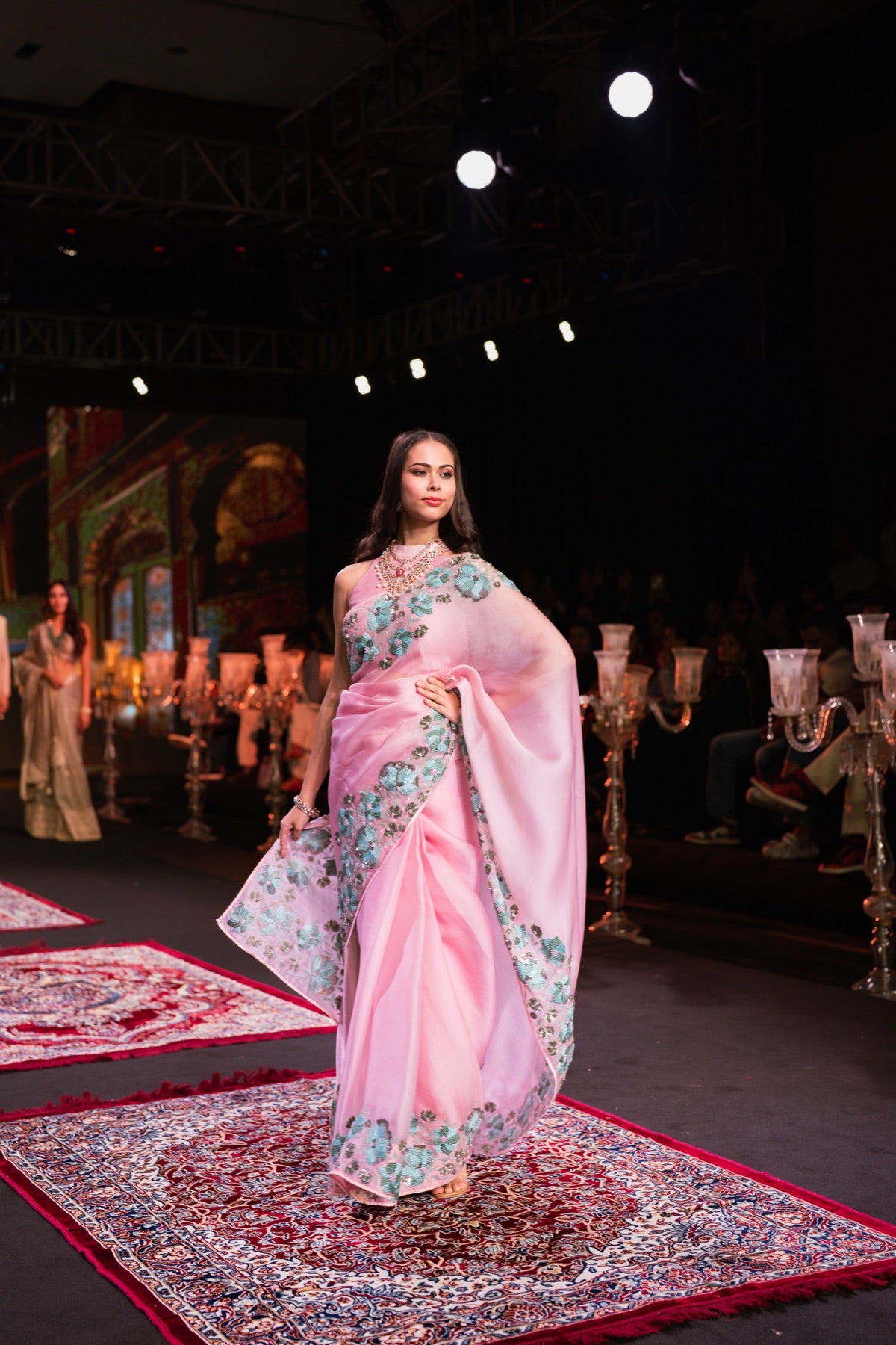 Model in a pink floral-print saree on the runway