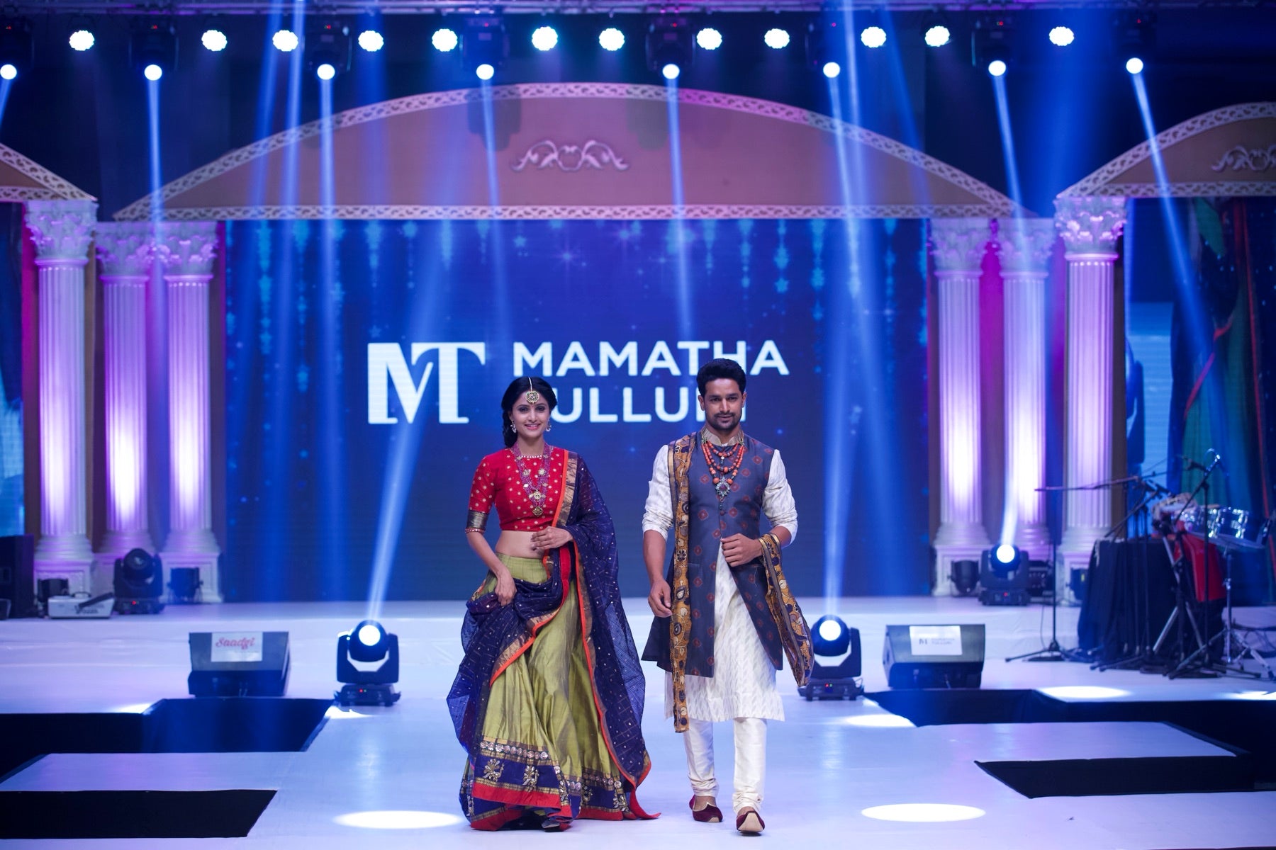 Couple look, red and gold-green lehenga paired with an indigo sherwani