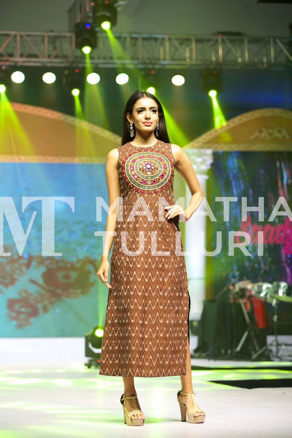Model in a brown printed dress on the runway